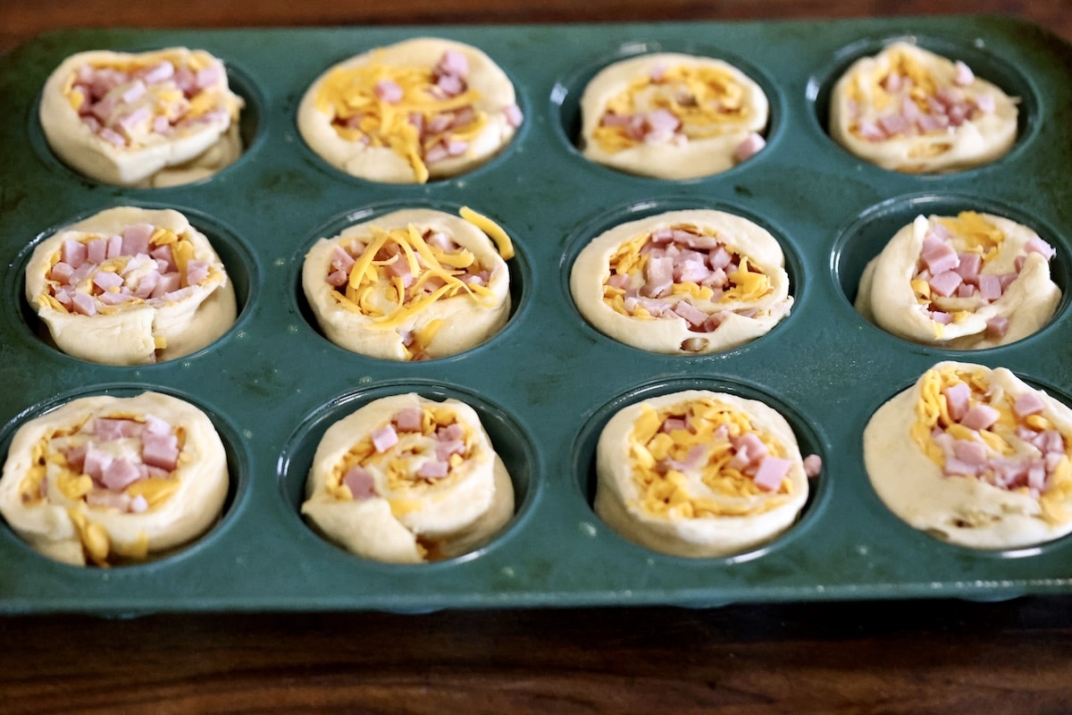 Crescent dough muffins in a tin.