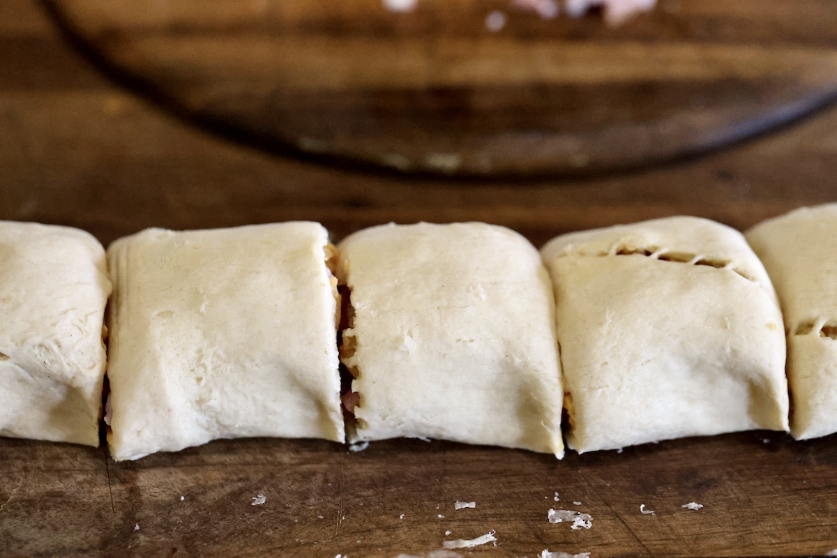 Crescent roll log sliced into rolls.
