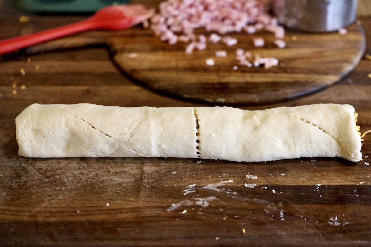 Crescent roll log filled with ham and cheese.