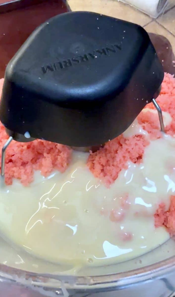 Mixing cake with sweetened condensed milk in a mixer.