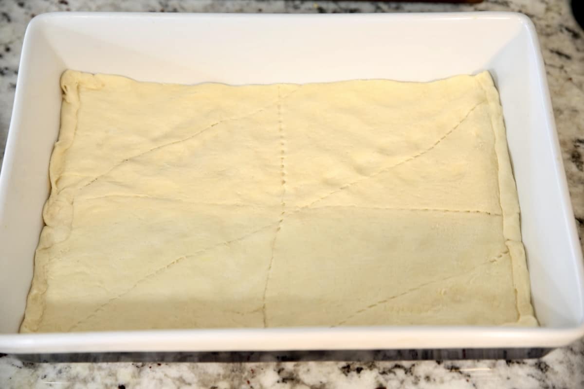 Crescent dough pressed into a baking dish for a crust.