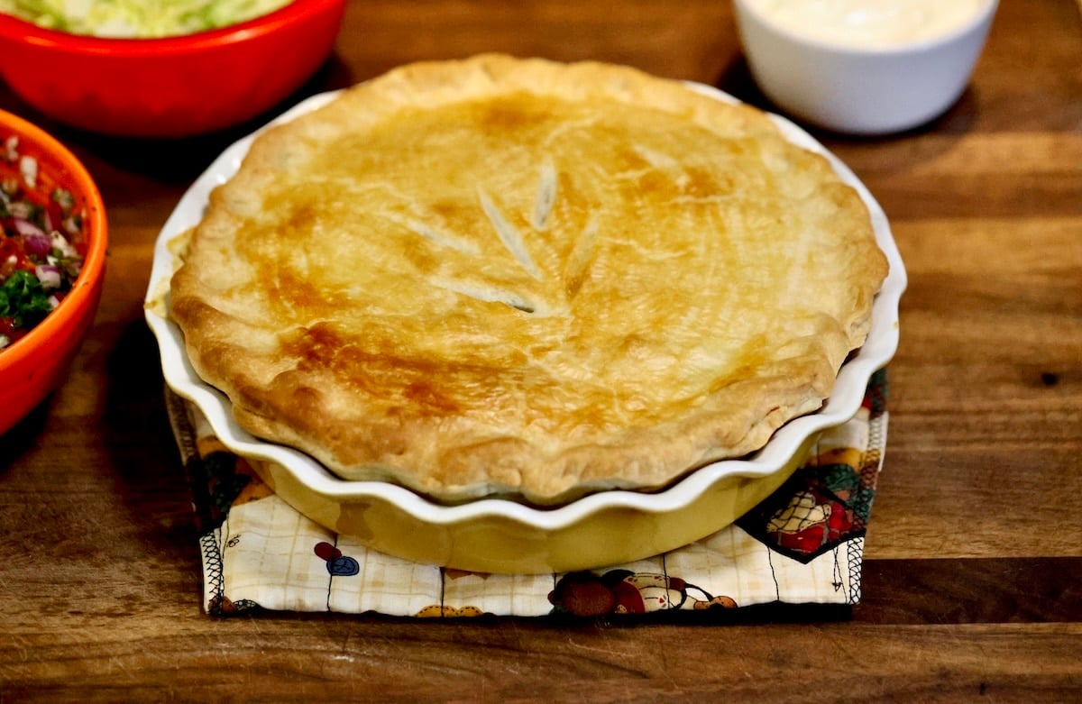 Baked pot pie on a cutting board.