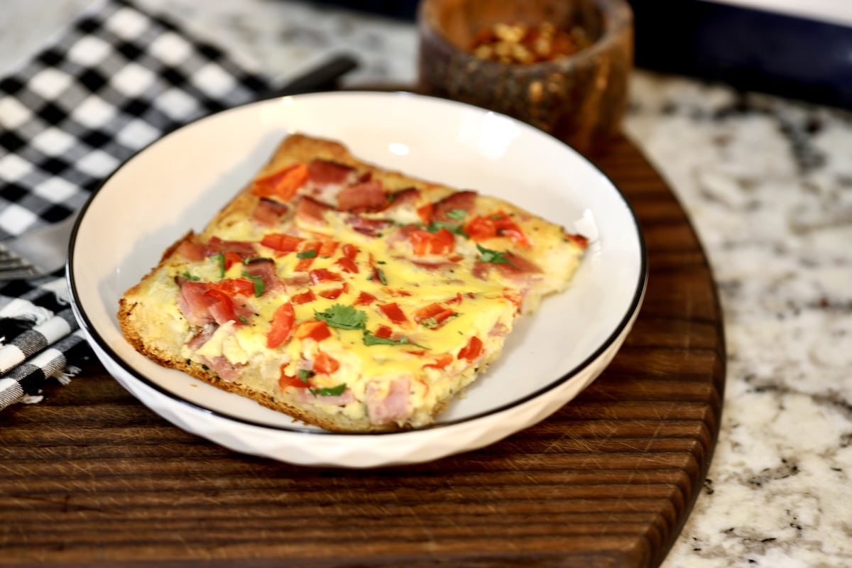 Breakfast bake cut into a square on a plate.