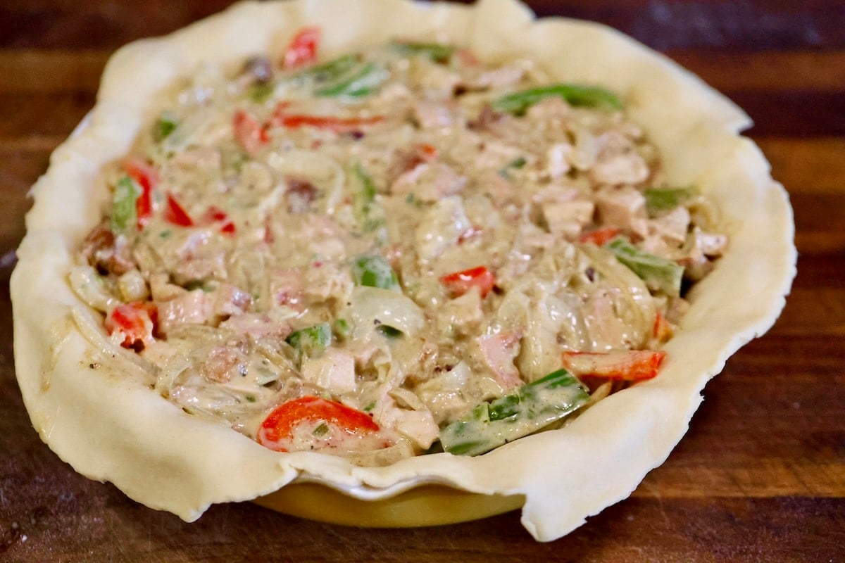 Making pot pie with chicken, peppers and onions.