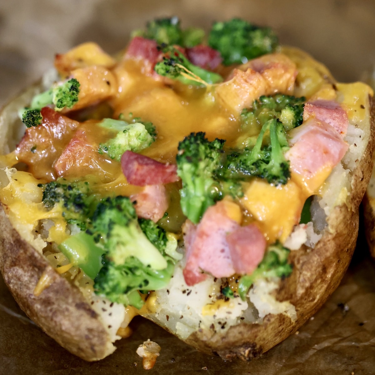 Loaded ham, broccoli and cheese potatoes. Loaded baked potato with ham, broccoli and melted cheese.