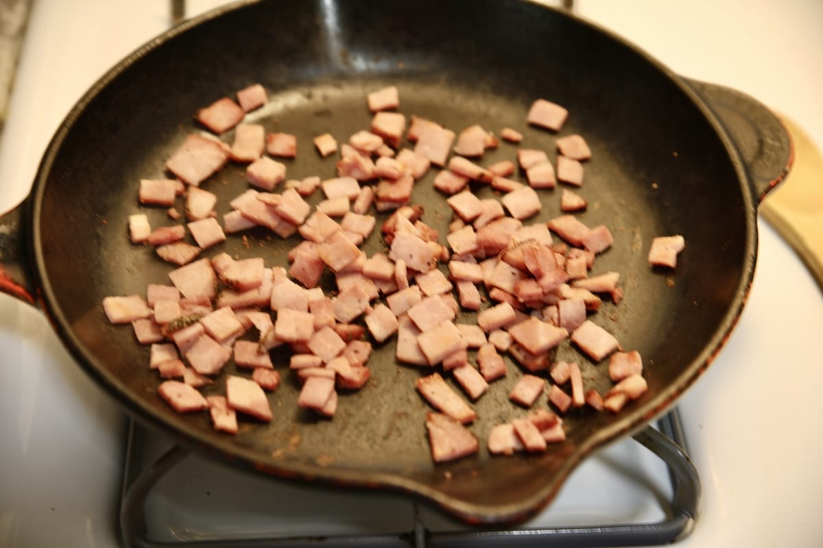 Diced ham in a skillet.