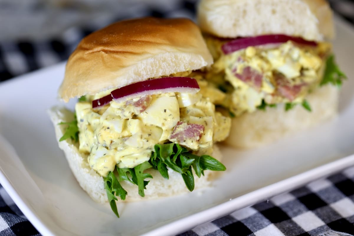 Brunch sliders with ham and egg salad on a plate.