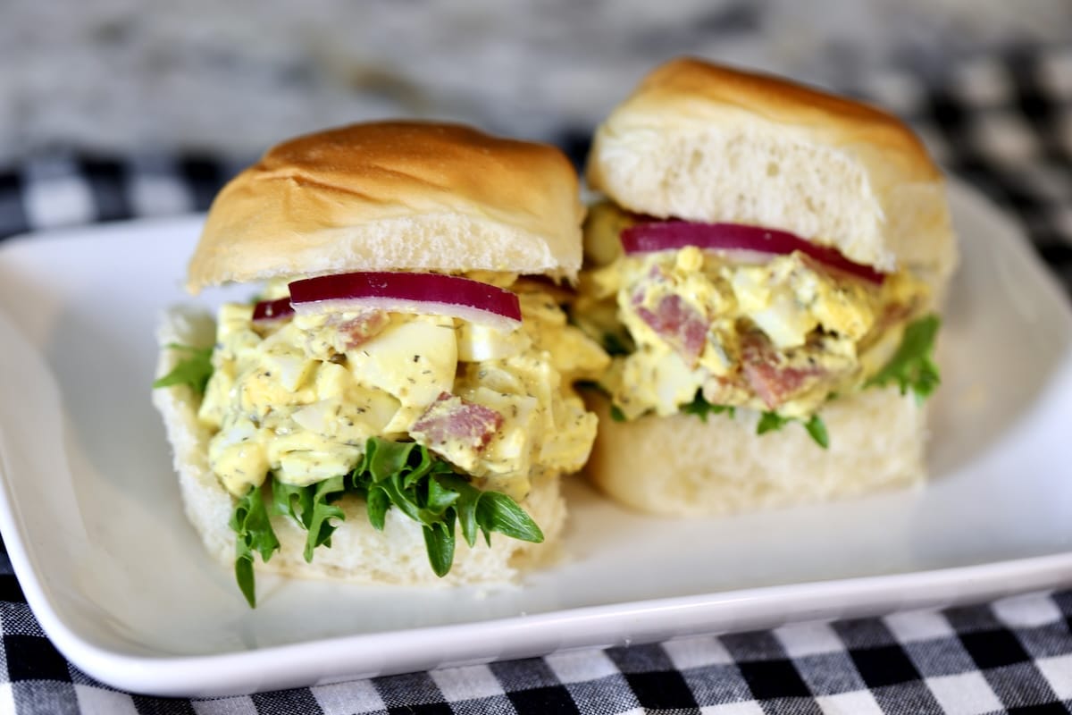 2 Ham and egg salad sliders on a plate.