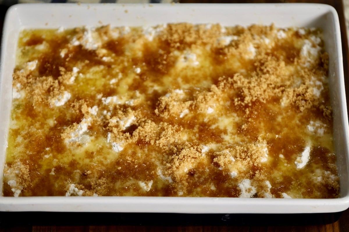 Dump cake with butter and brown sugar in a pan.