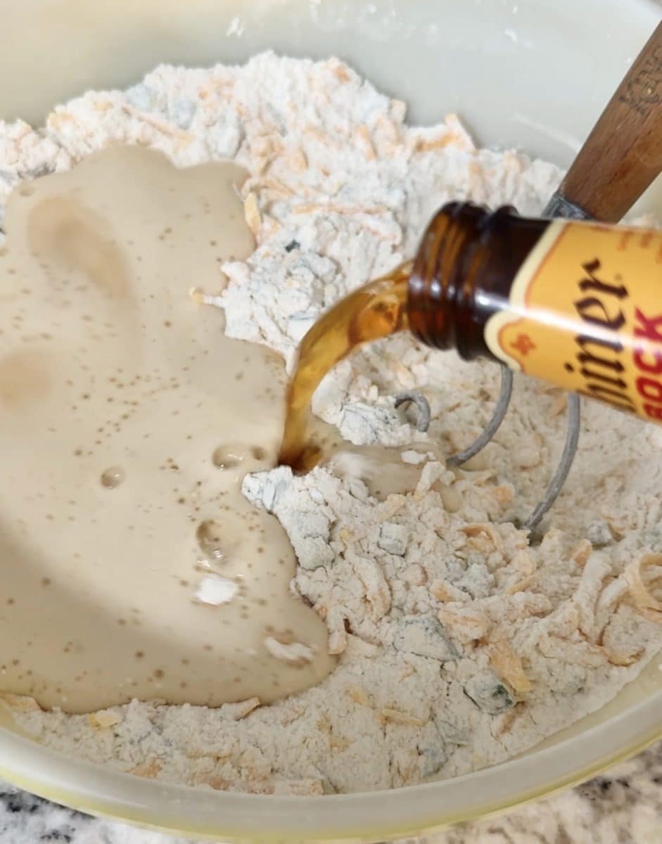 Pouring Shiner Bock beer into flour mixture for beer bread.