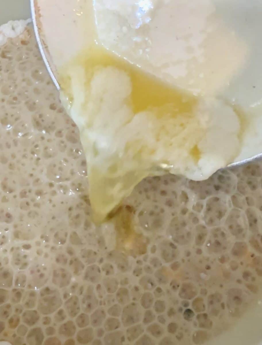 Pouring melted butter into beer bread batter.