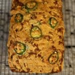 Cheddar Beer Bread loaf on a wire rack.