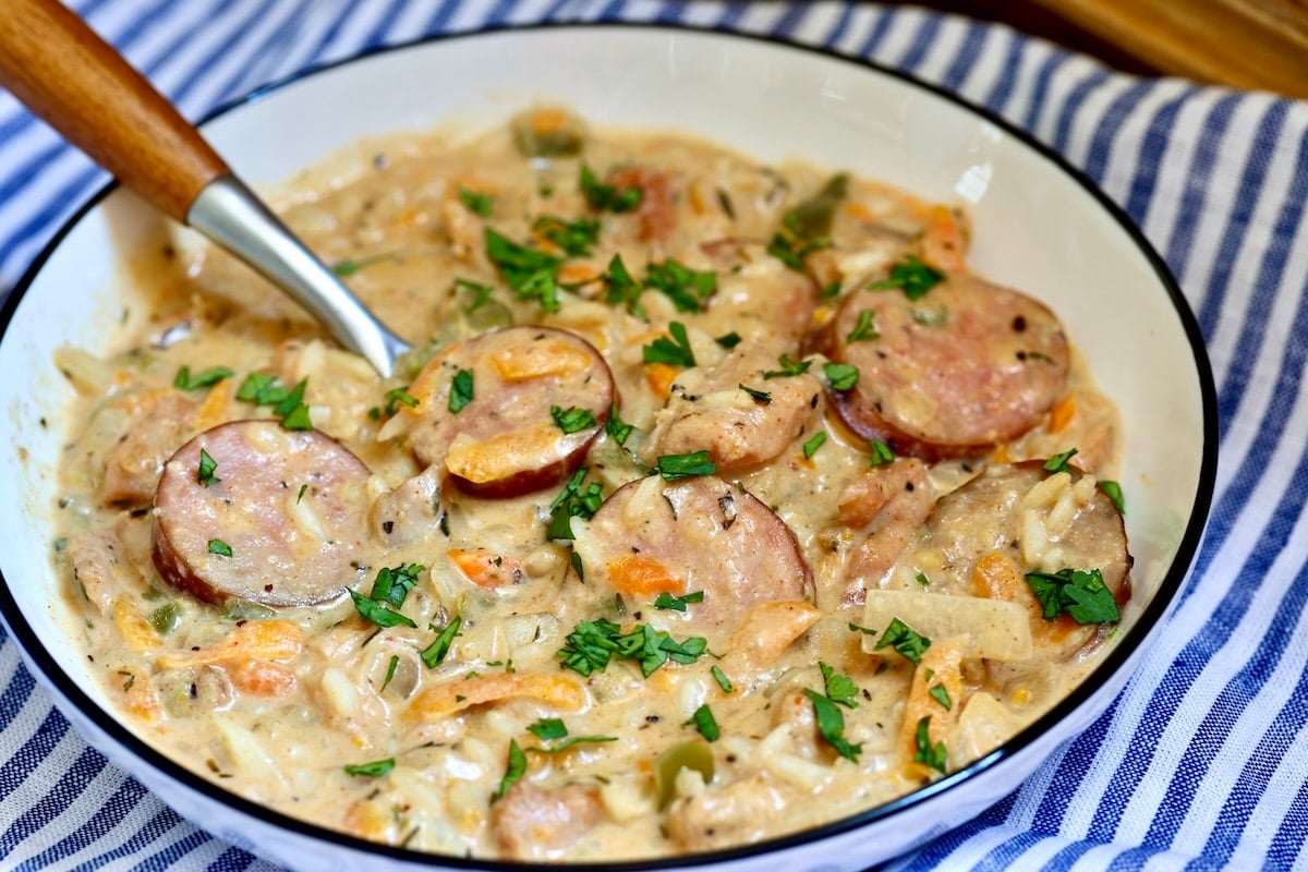 Bowl of chicken and rice with smoked sausage.